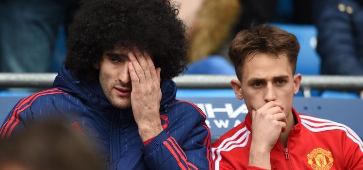Manchester United's Belgian midfielder Marouane Fellaini (L) reacts ahead of the English Premier League football match between Manchester City and Manchester United at the Etihad Stadium in Manchester, north west England, on March 20, 2016. / AFP / PAUL ELLIS / RESTRICTED TO EDITORIAL USE. No use with unauthorized audio, video, data, fixture lists, club/league logos or 'live' services. Online in-match use limited to 75 images, no video emulation. No use in betting, games or single club/league/player publications.  /         (Photo credit should read PAUL ELLIS/AFP/Getty Images)
